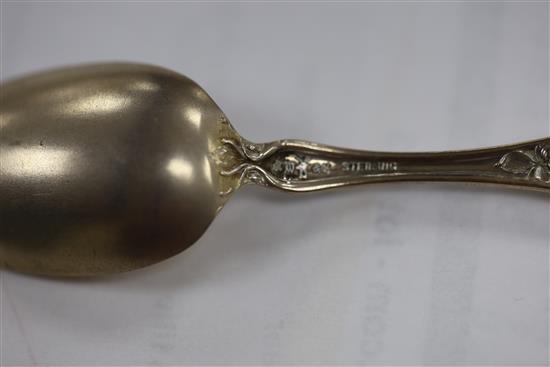 A set of twelve American sterling coffee spoons, the handles cast with scrolls, Venus and Cupid